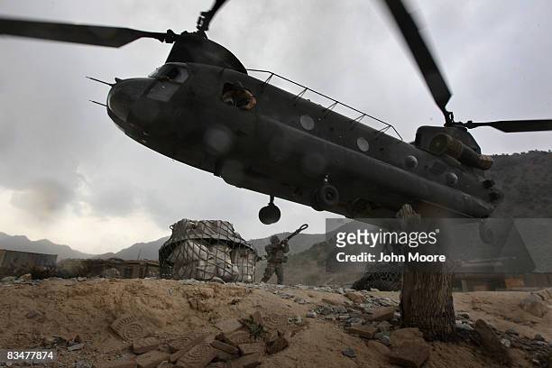Large load of mail sent to soldiers killed or wounded in action is attached to a Chinook helicopter by U.S. Army Staff Sgt. Michael Rodriguez for...