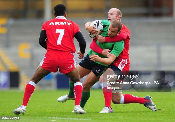 Leeds Met University's Ian Gordan is tackled by British Army's Eugene Viljoen during the Carnegie Floodlit Nines at Headingley Carnegie Stadium,...