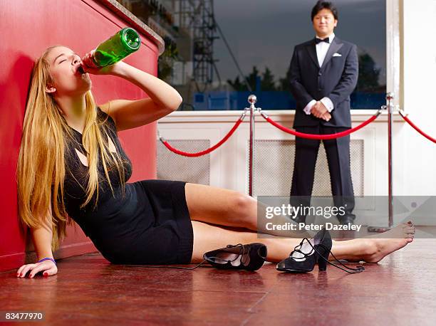 teenager drinking champagne on nightclub floor - substance abuse stock pictures, royalty-free photos & images