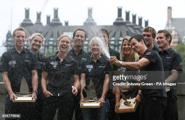 Olympic Sailing medallist Nick Rogers opens the champagne as fellow medallists Paul Goodison, Sarah Webb, Pippa Wilson, Ben Ainslie, Andrew Simpson,...