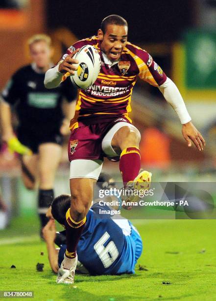 Huddersfield Giants' man of the match Leroy Cudjoe clears the tackle of Hull FC's Jack Briscoe to score a try during the final of the Carnegie...