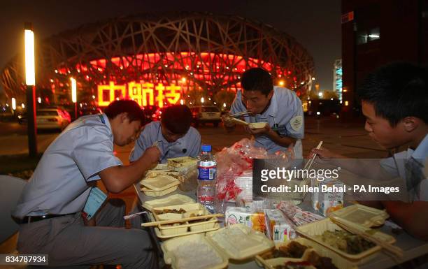 Chinese security guards take a break outside the "Birds Nest Stadium", as with the Olympic Games, the security is tight ahead of the opening ceremony...
