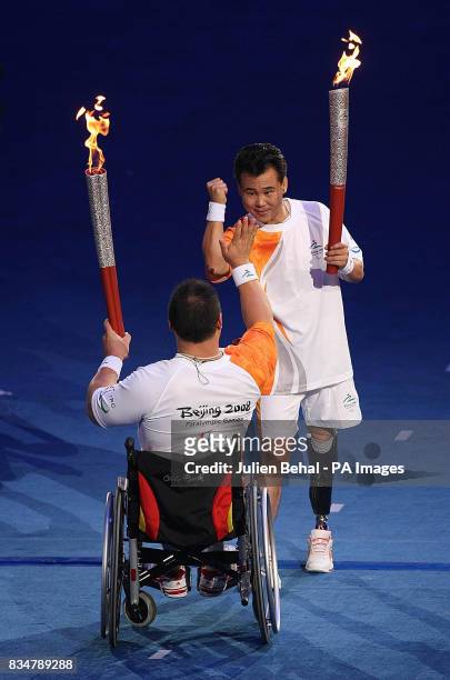 Athletes carries torches during the Beijing Paralympic Games 2008 Opening Ceremony at the National Stadium, Beijing, China.