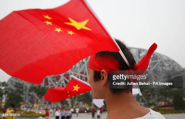 Chinese flag is waved outside the National Stadium, Beijing, China.