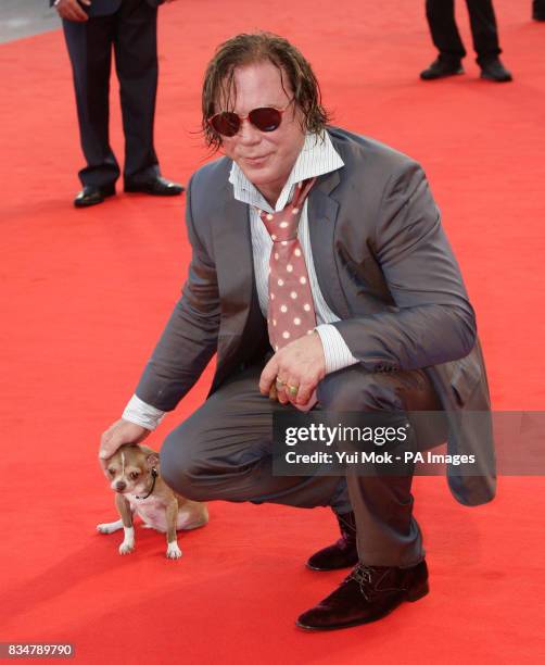 Mickey Rourke and his dog, Loki, arrive for the closing night ceremony of the festival, at the Palazzo del Cinema on Venice Lido, Italy, during the...