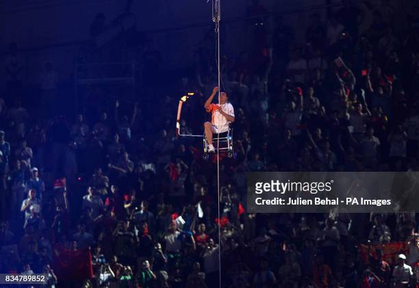 Performer raises the torch during the Beijing Paralympic Games 2008 Opening Ceremony at the National Stadium, Beijing, China.