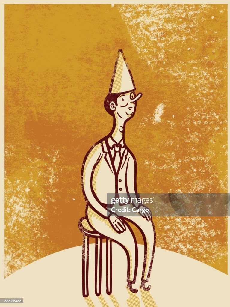 Drawing of a man wearing a dunce cap while sitting on a stool