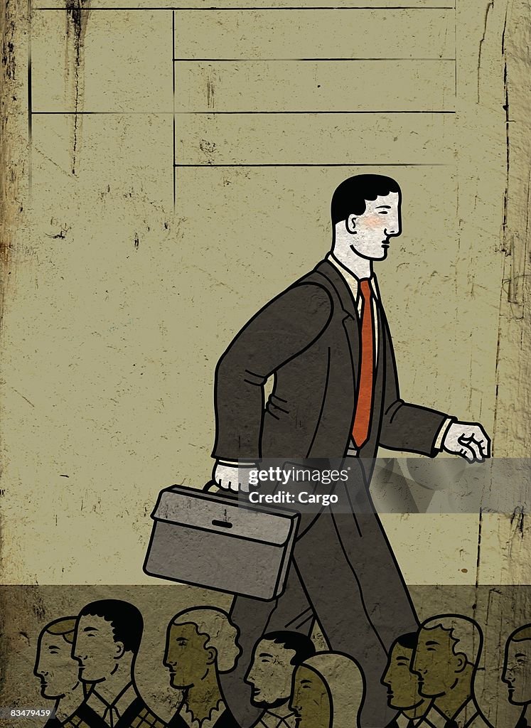 A tall businessman walking above a crowd