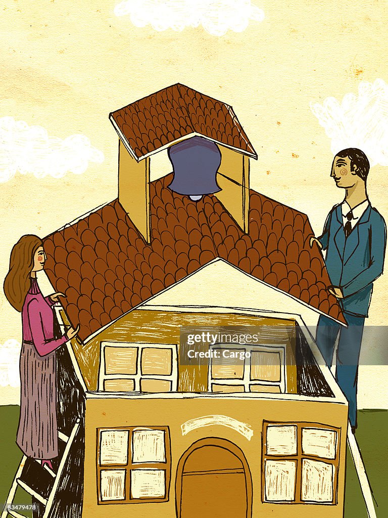 A man and woman placing the roof on a school building