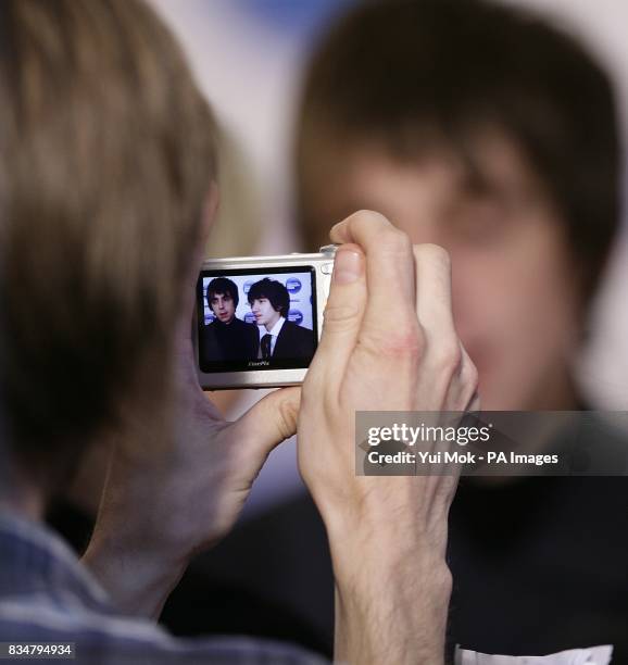 Fan takes a picture of Alex Turner and Miles Kane from The Last Shadow Puppets as they arrive for the Nationwide Mercury Prize at Grosvenor House,...