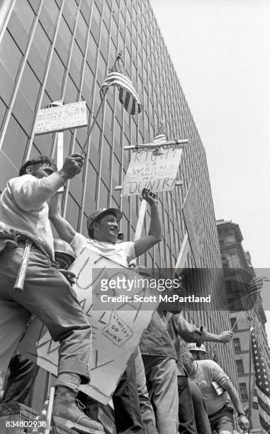 Downtown Manhattan May 1970: World Trade Center construction workers stand on a fence near City Hall, and angrily protest Mayor Lindsey's decision to...