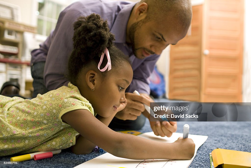 Father drawing with daughter