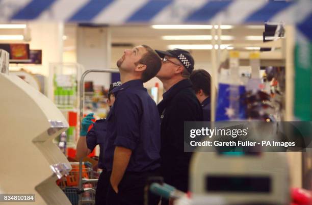 Police search officers investigate the Somerfield Supermarket in Littlehampton, West Sussex, where a 20 year old woman was stabbed yesterday.