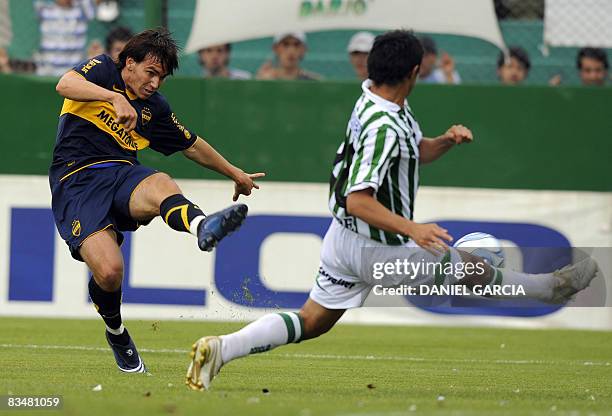 Boca Juniors forward Pablo Mouche scores against Banfield during their Apertura's tournement football match at El Taladro stadium in Banfield, Buenos...