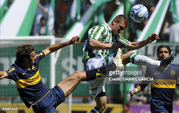 Boca Juniors defender Claudio Morel Rodriguez of Boca Juniors looks as teammate Jesus Datolo vies for the ball with midfielder Cristiasn Garcia of...