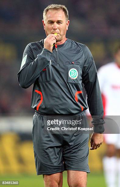 Referee Helmut Fleischer attends the 150th game during the Bundesliga match between 1. FC Koeln and Borussia Dortmund at the RheinEnergie stadium on...