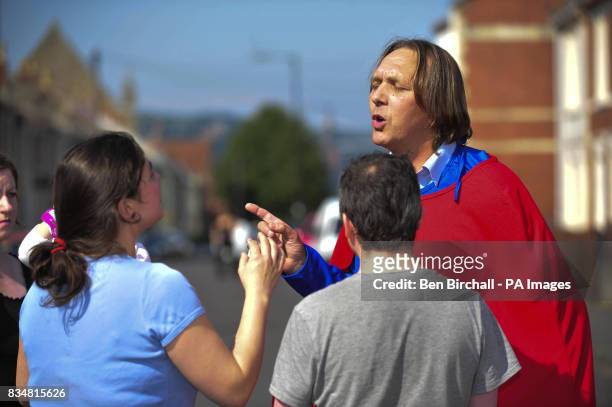Fathers 4 Justice protester Peter Semenenko speaks with residents near MP Dawn Primarolo's Bristol office in Bedminster.