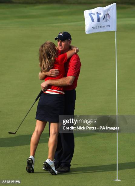 S Jim Furyk celebrates with his wife Tabitha on the 17th green after beating Miguel Angel Jimenez who concedes the hole which hands the Ryder Cup...