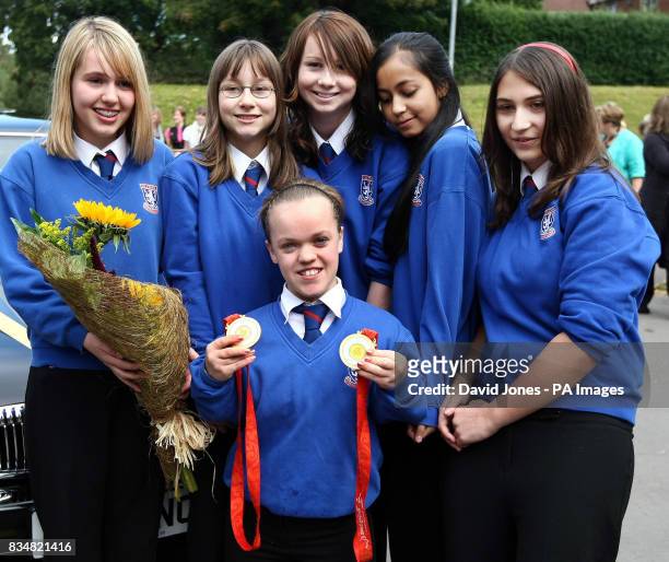 Paralympic swimmer Eleanor Simmonds, who is Britain's youngest ever individual Paralympic gold medallist, is welcomed back by classmates Amber Evans,...