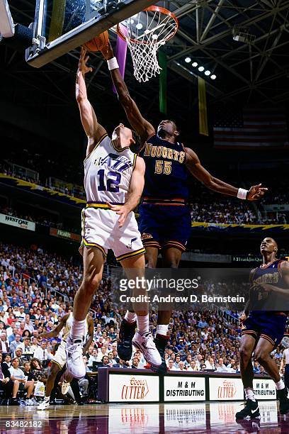 John Stockton of the Utah Jazz shoots a layup against Dikembe Mutombo of the Denver Nuggets during Game Five of the 1994 Western Conference...