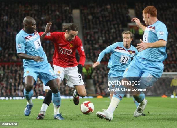 Dimitar Berbatov of Manchester United clashes with Herita Ilunga, Lee Bowyer and James Collins of West Ham United during the Barclays Premier League...