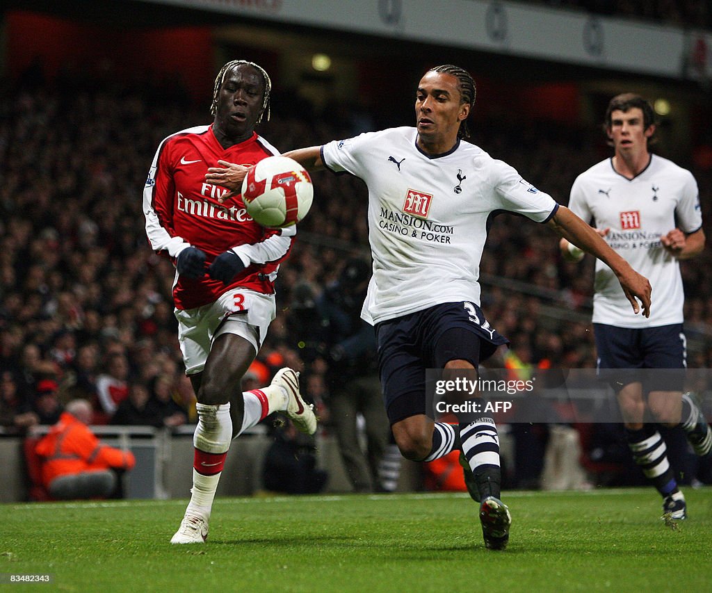 Arsenal's Bacary Sagna (L) clashes with