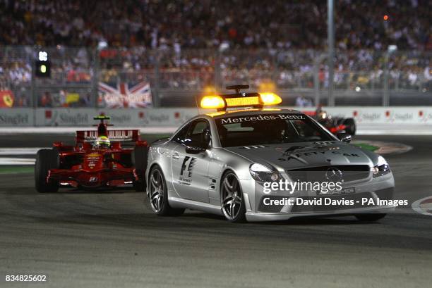 The safety cars come out after Renault's Nelsinho Piquet crashes out during the Singapore Grand Prix