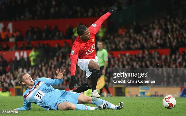 Patrice Evra of Manchester United clashes with Jack Collison of West Ham United during the Barclays Premier League match between Manchester United...