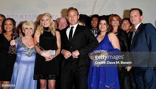 Jason Donovan poses with Barbara Windsor, Rita Simons, Steve McFadden, Nina Wadia Patsy Plamer, Perry Fenwick and "Eastenders" cast members with...