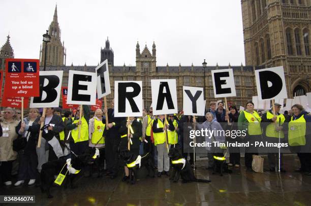 Blind and partially sighted protesters outside the Houses of Parliament on their way to lobby Government.