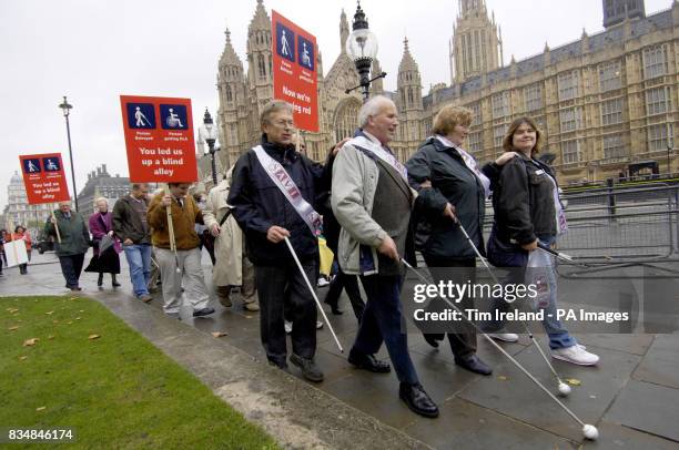 Blind and partially sighted protesters outside the Houses of Parliament on their way to lobby Government.