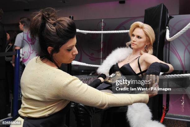 Caryn Bloom, wardrobe and hair assistant at Madame Tussaud's, removes Madonna's wedding ring from her waxwork, at Madame Tussauds in central London.