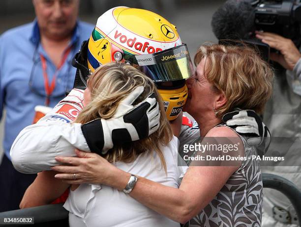 McLaren Mercedes' Lewis Hamilton celebrates his victory with his mother Carmen Lockhart and step mother Linda Hamilton during the Formula One Sinopec...