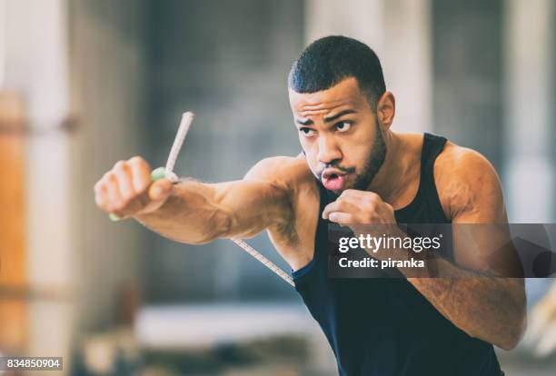 shadow boxing in an urban gym - shadow boxing stock pictures, royalty-free photos & images