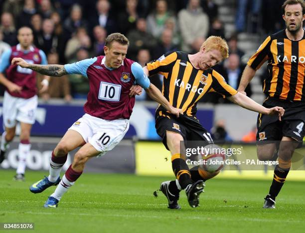 West Ham's Craig Bellamy in action with Hull City's Paul McShane during the Barclays Premier League match at the KC Stadium in Hull.