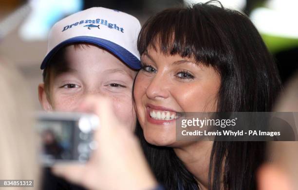 Actress Emma Barton has her picture taken by children at Heathrow, as a British Airways jumbo jet prepares to take nearly 200 seriously ill and...