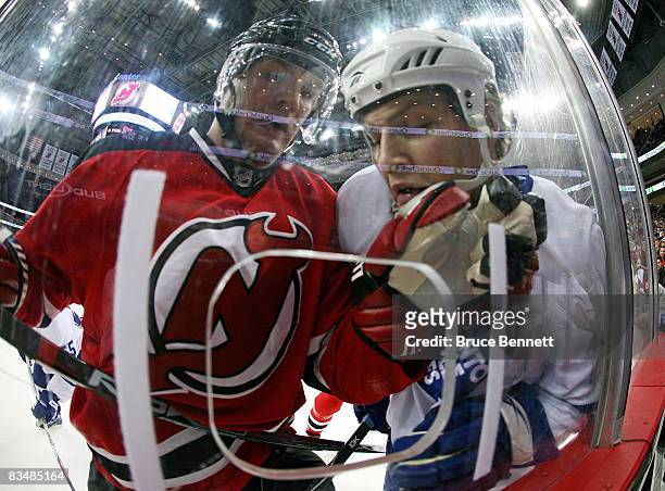 Colin White of the New Jersey Devils and John Mitchell of the Toronto Maple Leafs collide on the boards on October 29, 2008 at the Prudential Center...