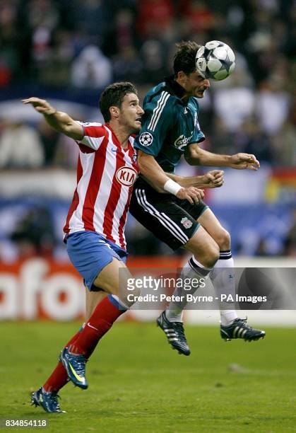 Athletico Madrid's Giourkas Seitaridis and Liverpool's Alberto Riera battle for the ball