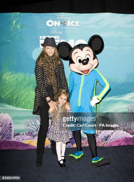 Television presenter Trinny Woodall and her daughter Lyla meet Mickey Mouse as they arrive for the London launch of Disney's production of...