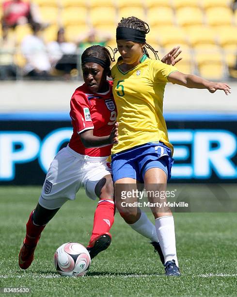 Dan Carter of England gets tackled by Bruna of Brazil during the Under 17 Womans World Cup match between the England and Brazil at Westpac Stadium on...