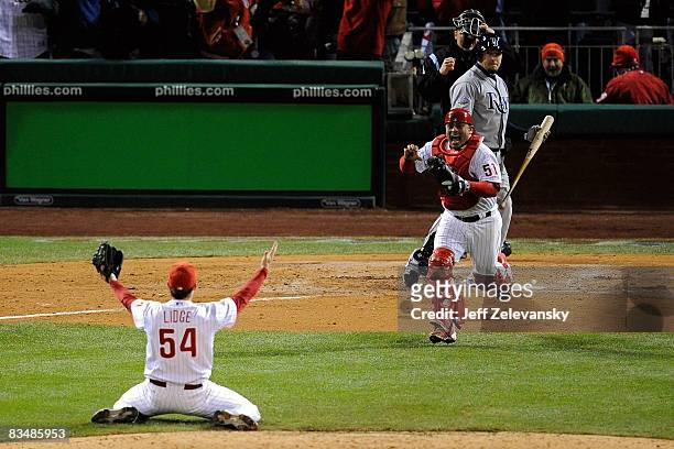 Catcher Carlos Ruiz and closing pitcher Brad Lidge of the Philadelphia Phillies celebrate after recording the final out by striking out Eric Hinske...