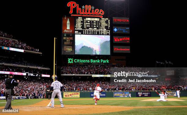 Catcher Carlos Ruiz and closing pitcher Brad Lidge of the Philadelphia Phillies celebrate after recording the final out by striking out Eric Hinske...