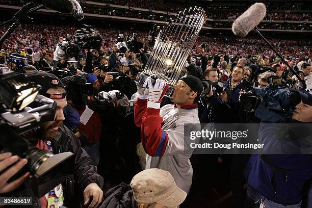 Greg Dobbs of the Philadelphia Phillies celebrates with the World Series Championship trophy after their 4-3 win against the Tampa Bay Rays during...