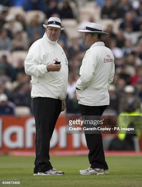 Match umpires Darrell Hair and Simon Taufel check the light
