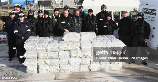 Armed Naval and Gardai personnel with the half a billion euro of cocaine which was seized from a yacht off the west coast of Ireland, in the harbour...