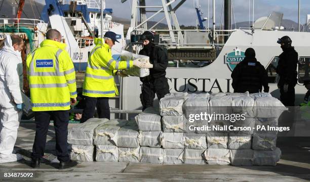 Armed Naval and Gardai personnel with the half a billion euro of cocaine which was seized from a yacht off the west coast of Ireland, in the harbour...