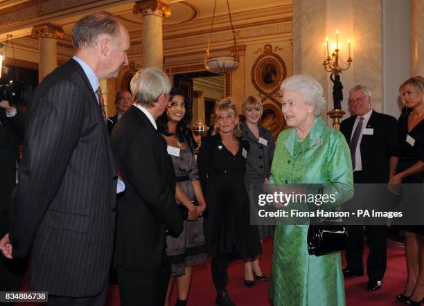 Queen Elizabeth II receives Blue Peter presenters, from left to right: John Noakes, Konnie Huq, Lesley Judd, and Diane-Louise Jordan, during a...