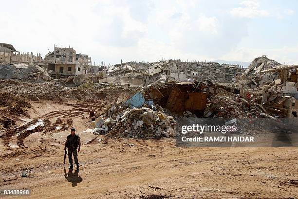 Lebanese soldier stands guard amid the ruined buildings in the destroyed old part of the Palestinian refugee camp of Nahr al-Bared in northern...