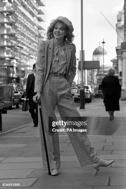 Model Gigi in Donegal tweed trousers and jacket teamed with a striped floppy tie blouse part of Reldan's collection shown in London.