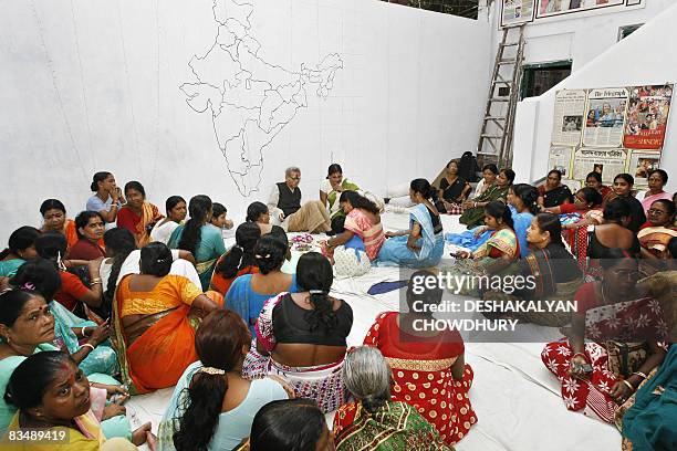 Indian sex workers perform a ritual in observance of 'Bhai Phonta' festival in Kolkata on October 30, 2008. Bhai Phonta is a festival where sisters...